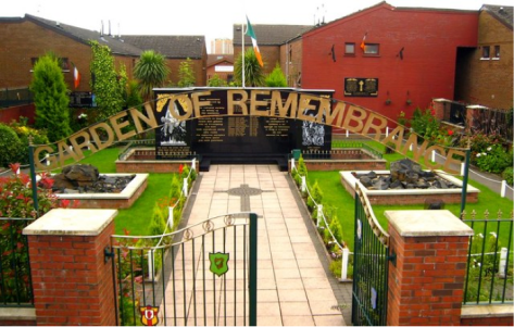 Garden of Remembrance, Falls Road. This area includes a collection of plaques and memorials dedicated to the nationalist lives that were lost. The plaques list names of individuals and ranges of years that the deaths of the remembered individuals took place. Several Irish flags fly at the back of the photo. Photo Credit: geograph.org.uk