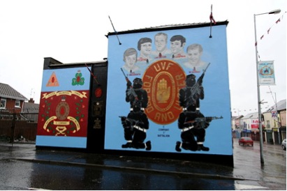An Ulster Volunteer Force (UVF) mural. Despite, their name, the UVF was a loyalist armed paramilitary group that campaigned during The Troubles. The emblem is the middle is a representation of the UVF with the Red Hand of Ulster and the words “For God and Ulster”. This mural is dedicated to C Company 1st Battalion. This picture is an older one and the mural has been replaced partially with the 3rd image